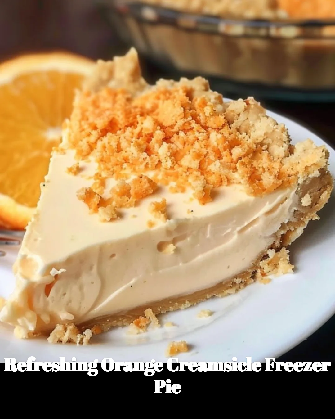 Refreshing orange creamsicle freezer pie topped with whipped cream and orange slices.