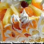 Slice of refreshing Southern Pineapple Orange Swirl Cheesecake with tropical fruit topping