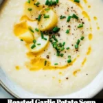 Delicious bowl of roasted garlic potato soup served with fresh herbs