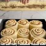 Delicious cinnamon-walnut rolls with cream cheese frosting on a plate