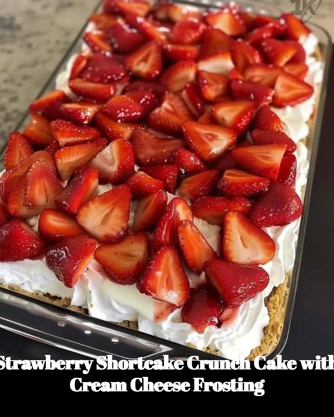 Strawberry Shortcake Crunch Cake with cream cheese frosting on a rustic table