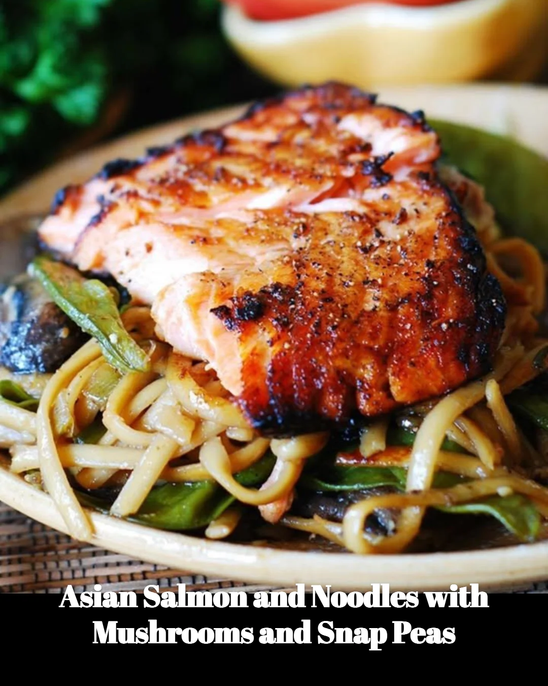 Asian salmon dish featuring noodles, mushrooms, and snap peas