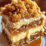 Slice of autumn pumpkin spice crumble cake topped with cinnamon and nuts