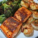 Cajun Salmon with Garlic Butter Shrimp and Roasted Broccoli on a plate