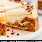Delicious carrot cake cheesecake topped with pecans on a white plate