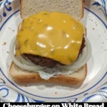 Delicious cheeseburger served on white bread with fresh toppings