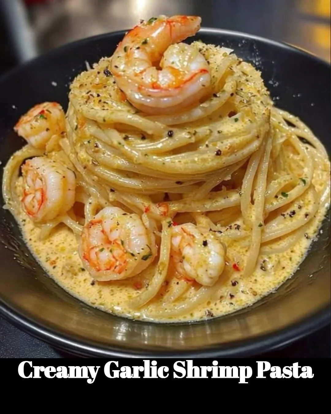 Creamy garlic shrimp pasta with fresh ingredients and herbs in a bowl.