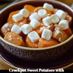 Crockpot sweet potatoes topped with marshmallows ready to serve