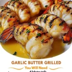 Garlic butter grilled lobster tails served on a plate with garnish.