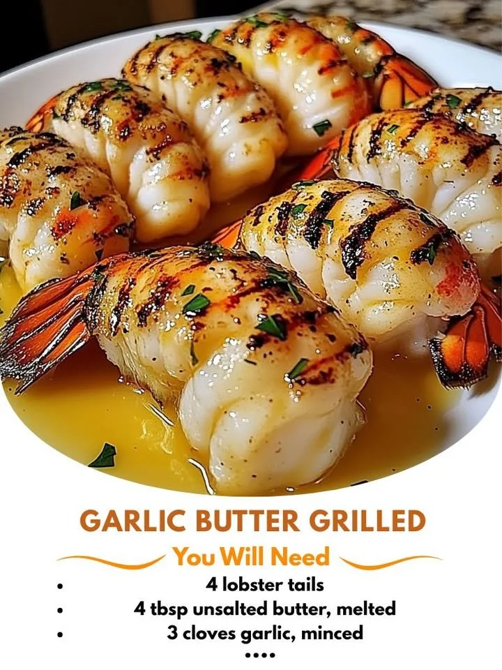 Garlic butter grilled lobster tails served on a plate with garnish.
