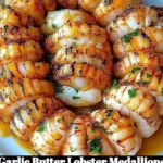Delicious Garlic Butter Lobster Medallions served on a plate garnished with herbs