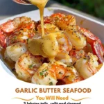 Plate of Garlic Butter Lobster and Shrimp Tails garnished with herbs