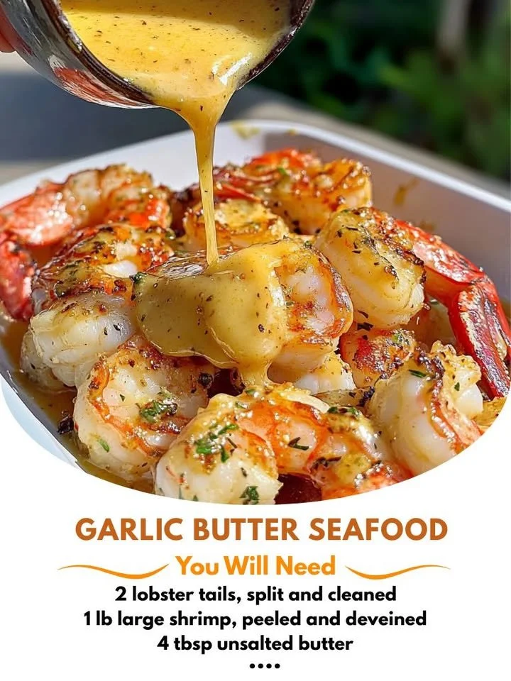 Plate of Garlic Butter Lobster and Shrimp Tails garnished with herbs