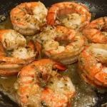 Plate of garlic butter lobster tail bites garnished with herbs