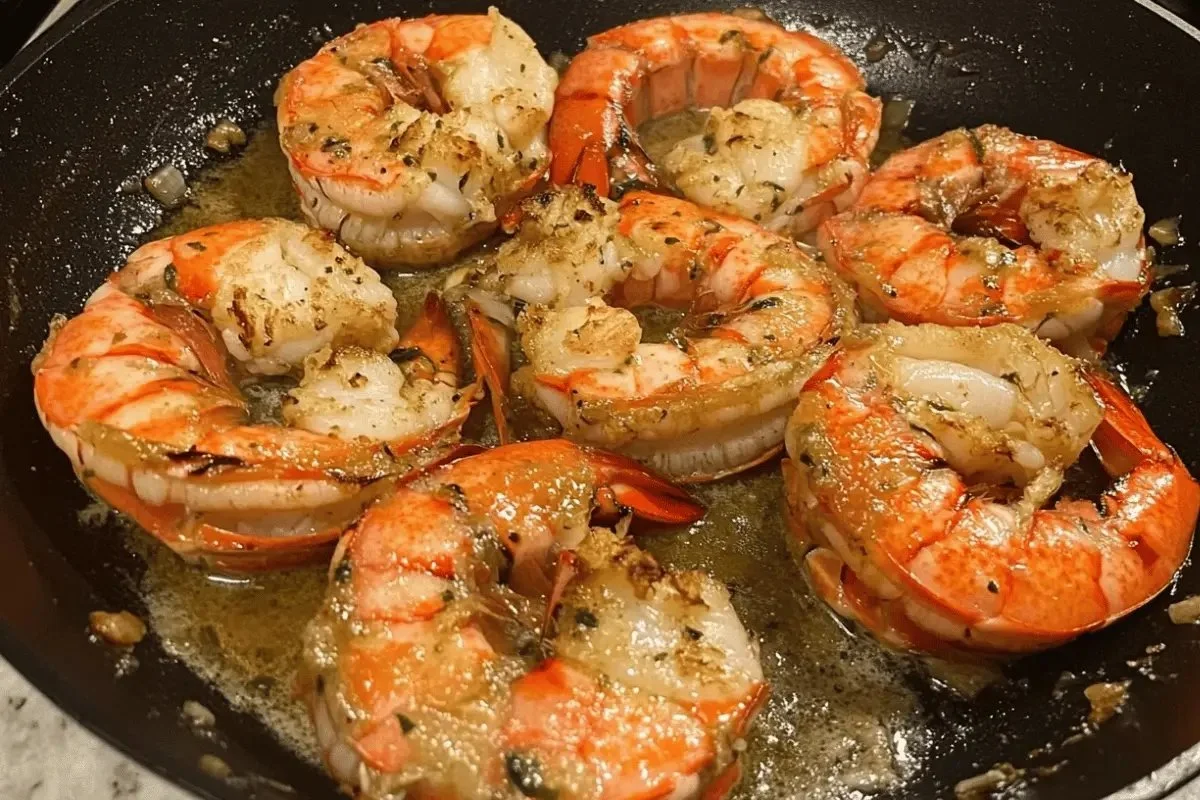 Plate of garlic butter lobster tail bites garnished with herbs