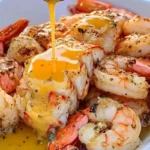 Delicious Garlic Butter Shrimp and Lobster dish garnished with herbs
