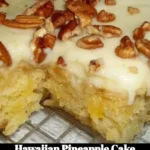 Slice of Hawaiian Pineapple Cake topped with whipped cream and fresh pineapple slices