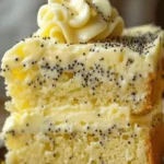 Homemade lemon poppy seed cake with a slice cut out, showcasing its moist texture.