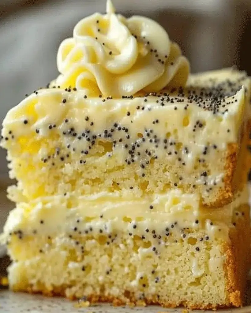 Homemade lemon poppy seed cake with a slice cut out, showcasing its moist texture.
