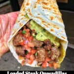 Delicious loaded steak quesadillas with cheese and toppings.