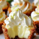 No-bake mini key lime pies topped with whipped cream and lime zest.