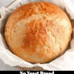 Slice of freshly baked no yeast bread on a wooden cutting board