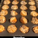 Stack of fluffy pancakes drizzled with syrup and topped with fresh berries