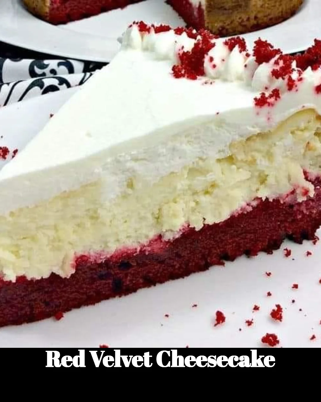 Slice of Red Velvet Cheesecake topped with cream cheese frosting on a plate