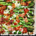 Plate of roasted asparagus with bacon, garlic, and cheese topping