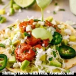 Shrimp tacos topped with feta, avocado, and creamy cilantro-lime sauce