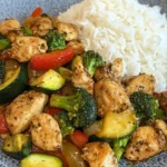 Spicy Garlic Chicken Stir-Fry served with rice in a colorful bowl
