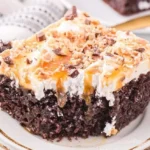 Decadent Reese's cake topped with chocolate and Heath bars, perfect for dessert.