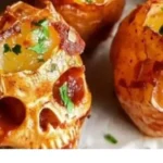 Creepy Halloween skull-shaped spooky potatoes served on a platter.