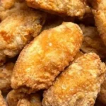 Plate of Mom's Crispy Chicken Wings with a side of dipping sauce