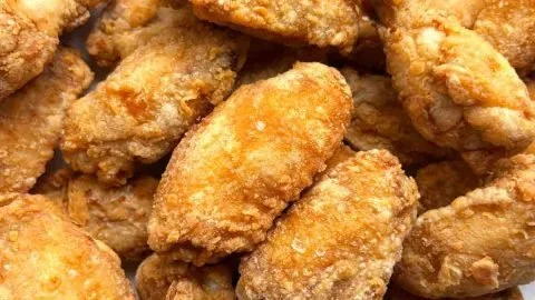Plate of Mom's Crispy Chicken Wings with a side of dipping sauce